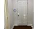 Secure entryway featuring a white door, security system, and hardwood floors at 868 Still Hill Ln, Lawrenceville, GA 30045