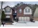 Charming two-story brick home boasts an attached two-car garage and a well-manicured front lawn at 868 Still Hill Ln, Lawrenceville, GA 30045