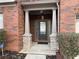 Inviting brick home entrance with stone accents and covered porch at 868 Still Hill Ln, Lawrenceville, GA 30045