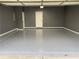 Clean, painted garage with epoxy floors and a pedestrian door at 868 Still Hill Ln, Lawrenceville, GA 30045