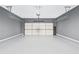 Spacious two-car garage with epoxy flooring and white doors at 868 Still Hill Ln, Lawrenceville, GA 30045