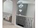 A modern hallway features eye-catching lighting, decorative railing, and a view of the lower level at 868 Still Hill Ln, Lawrenceville, GA 30045
