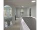 This neutrally decorated hallway features carpet flooring, white walls, and views to the exterior through multiple windows at 868 Still Hill Ln, Lawrenceville, GA 30045