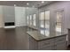 Open-concept kitchen featuring granite countertops, an island, and dark hardwood floors at 868 Still Hill Ln, Lawrenceville, GA 30045