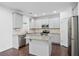 Stylish kitchen with stainless steel appliances, center island, and sleek gray cabinets at 868 Still Hill Ln, Lawrenceville, GA 30045