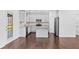 Bright kitchen boasting an island, stainless steel appliances, and convenient access to the outdoors at 868 Still Hill Ln, Lawrenceville, GA 30045