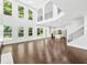Bright and open living room with hardwood floors, staircase, and modern lighting at 868 Still Hill Ln, Lawrenceville, GA 30045