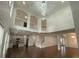 Open living area with hardwood floors, high ceilings, wrought iron railing and modern lighting at 868 Still Hill Ln, Lawrenceville, GA 30045