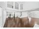 Large living room showcasing open concept with high ceilings, hardwood floors, and lots of natural light at 868 Still Hill Ln, Lawrenceville, GA 30045