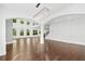 Spacious room highlighting hardwood floors, high ceilings, modern lighting, and ample natural light at 868 Still Hill Ln, Lawrenceville, GA 30045