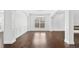 Open living room featuring hardwood floors, modern lighting, and stylish wainscoting for an elegant look at 868 Still Hill Ln, Lawrenceville, GA 30045