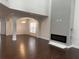 Open-concept living room with hardwood floors and a sleek, modern fireplace at 868 Still Hill Ln, Lawrenceville, GA 30045