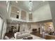 Open-concept living room with high ceilings, modern lighting, and elegant staircase at 868 Still Hill Ln, Lawrenceville, GA 30045