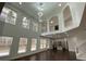 Sun-filled living room with tall windows and a view of the kitchen at 868 Still Hill Ln, Lawrenceville, GA 30045