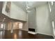Bright living room featuring a high ceiling, modern fireplace, and elegant lighting at 868 Still Hill Ln, Lawrenceville, GA 30045