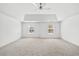 Large main bedroom with neutral carpet, tray ceiling, and two windows at 868 Still Hill Ln, Lawrenceville, GA 30045