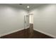 A well-lit room with wood floors, white walls and trim, and a glass-paneled door at 868 Still Hill Ln, Lawrenceville, GA 30045