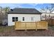 View of backyard featuring a newly constructed wooden deck and white siding at 139 Dahlia Nw Ave, Atlanta, GA 30314