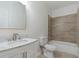 Elegant bathroom featuring a marble countertop vanity, a toilet, and a tiled shower-tub combo at 139 Dahlia Nw Ave, Atlanta, GA 30314