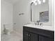 Modern bathroom featuring a dark vanity with granite countertops and contemporary fixtures at 139 Dahlia Nw Ave, Atlanta, GA 30314