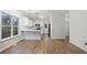 Cozy kitchen and dining area with hardwood floors, a breakfast bar, and stainless appliances at 139 Dahlia Nw Ave, Atlanta, GA 30314