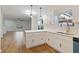 Bright, modern kitchen with quartz countertops, stainless steel sink, and white cabinets at 139 Dahlia Nw Ave, Atlanta, GA 30314