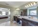 Bathroom featuring double sink vanity, large mirror, and walk-in shower at 2225 Independence Ln, Buford, GA 30519