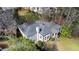 Aerial view of the home showing the roof, chimney, bay window, and surrounding foliage at 2836 Alpine Ne Rd, Atlanta, GA 30305
