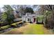 Charming home featuring a red front door, bay window, and a lush green lawn at 2836 Alpine Ne Rd, Atlanta, GA 30305