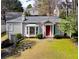 Charming one-story home featuring a red door, bay window, and beautifully landscaped front yard with stone walkway at 2836 Alpine Ne Rd, Atlanta, GA 30305