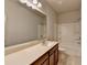 Bathroom with large mirror, brown cabinets, and tile flooring at 1676 Charcoal Ives Rd, Lawrenceville, GA 30045