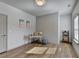 Neutral colored bedroom with luxury vinyl plank flooring and desk area with natural light from the window at 1676 Charcoal Ives Rd, Lawrenceville, GA 30045