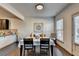 Cozy dining area with modern table setting, hardwood floors, and natural light at 1676 Charcoal Ives Rd, Lawrenceville, GA 30045