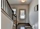 Inviting entryway with dark hardwood floors, staircase, and natural light from the front door at 1676 Charcoal Ives Rd, Lawrenceville, GA 30045