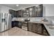 Stylish kitchen featuring stainless steel appliances, granite countertops, tile backsplash, and dark wood cabinets at 1676 Charcoal Ives Rd, Lawrenceville, GA 30045