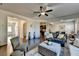 Open living room with hardwood floors, comfortable seating, and a view into the dining area at 1676 Charcoal Ives Rd, Lawrenceville, GA 30045