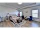 Spacious bedroom with tray ceiling, wood floors, a sitting area, and plenty of natural light at 1676 Charcoal Ives Rd, Lawrenceville, GA 30045