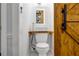 Compact bathroom featuring modern toilet, vessel sink, mirror, and barn door entry at 1747 Parkhill Dr, Decatur, GA 30032