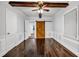 Bedroom with hardwood floors, neutral walls, a sliding barn door, and wooden beam at 1747 Parkhill Dr, Decatur, GA 30032