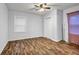 Bright bedroom with wood floors, ceiling fan, and a closet; neutral colors at 1747 Parkhill Dr, Decatur, GA 30032