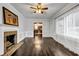 Cozy living room features a fireplace, hardwood floors, wainscoting, and large windows at 1747 Parkhill Dr, Decatur, GA 30032