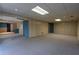 Large finished basement area with carpeted flooring and multiple access doors at 1958 Starfire Ne Dr, Atlanta, GA 30345