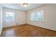 Well-lit bedroom with hardwood floors and two windows at 1958 Starfire Ne Dr, Atlanta, GA 30345