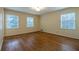 Spacious bedroom with hardwood floors and three windows for ample natural light at 1958 Starfire Ne Dr, Atlanta, GA 30345