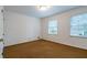 Bedroom with a large window for natural light and carpeting, and a closet at 1958 Starfire Ne Dr, Atlanta, GA 30345