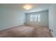 Bedroom with neutral paint, carpet flooring, standard lighting and a window at 1958 Starfire Ne Dr, Atlanta, GA 30345