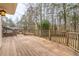 Well-maintained wooden deck with railing overlooking a lush yard and wooded backdrop at 1958 Starfire Ne Dr, Atlanta, GA 30345