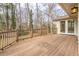 Spacious wooden deck with railing overlooks the lush green yard and trees at 1958 Starfire Ne Dr, Atlanta, GA 30345