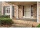 Inviting front porch with brick steps and pillars leading to a classic white front door with black shutters at 1958 Starfire Ne Dr, Atlanta, GA 30345