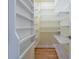 Walk-in closet with shelving and hanging space, providing ample storage, with hardwood floors at 1958 Starfire Ne Dr, Atlanta, GA 30345